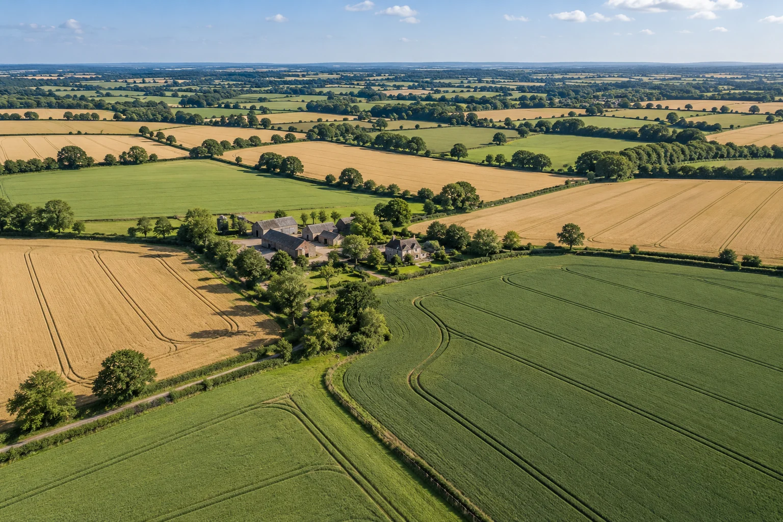 Patchwork fields and a farmstead seen from above